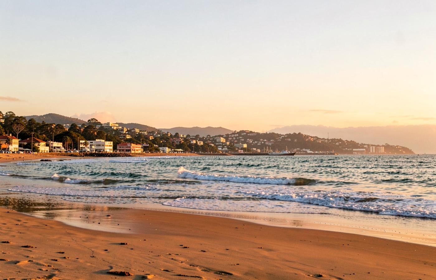 Gqeberha coastline at golden hour with gentle waves and warm sand